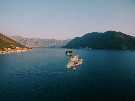 Boat sails along the Bay of Kotor to the island of Gospa od Skrpjela. Montenegro. High quality photo