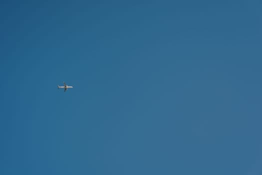 Passenger plane flies in the clear blue sky. High quality photo