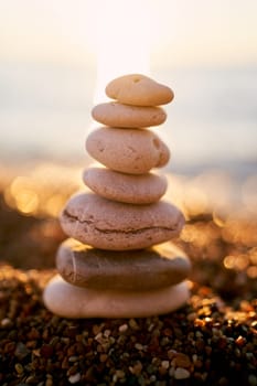 Cairn lies on the seashore in bright sunshine. High quality photo