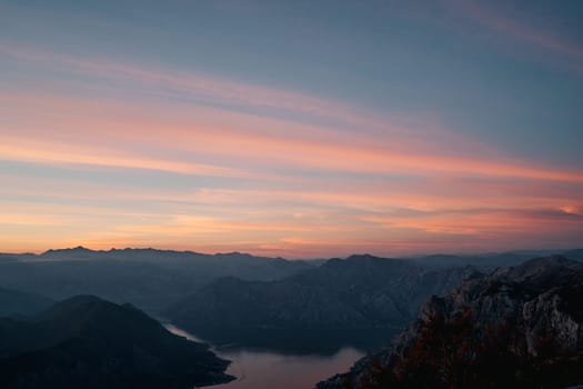 Sunset sky over a mountain range by the bay. High quality photo