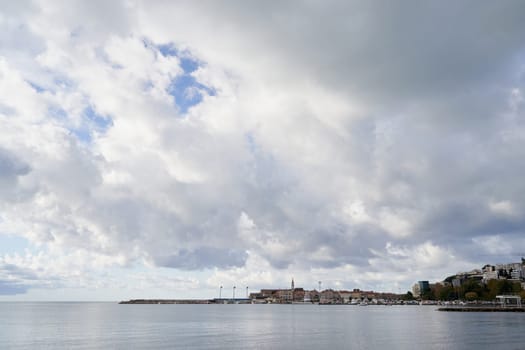 Cloudy sky over an ancient town on the coast. High quality photo