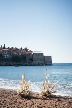 Wedding semi-arch on the seashore overlooking the island of Sveti Stefan. Montenegro. High quality photo