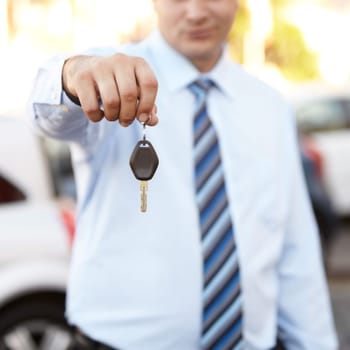 Businessman, hand and key to car outdoor with sale of auto, transportation and investment. Vehicle, dealership or man with keys in parking lot from salesman for test drive, opportunity or driving.