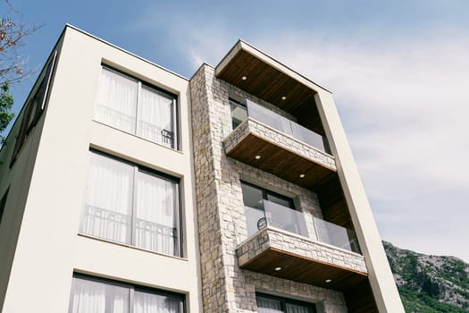 Modern multi-storey hotel with terraces with glass railings. High quality photo