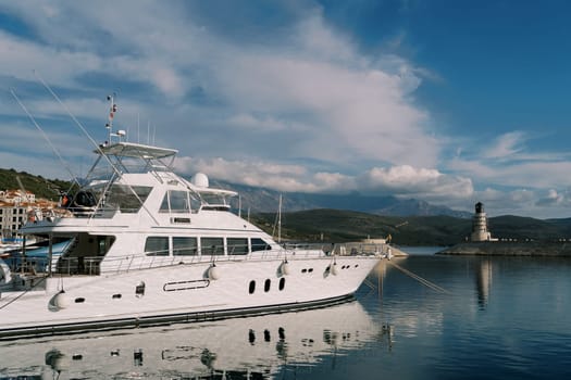 White yacht moored in Lustica Bay overlooking the lighthouse. Montenegro. High quality photo