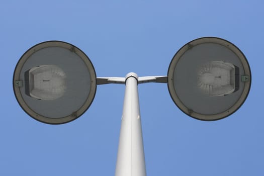Street lamp with two spotlights,blue sky in the background