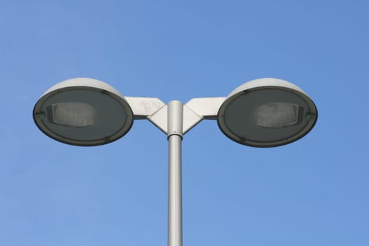 Street lamp with two spotlights,blue sky in the background