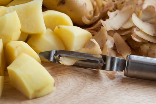 Peeled and cut potatoes with vegetable peeler