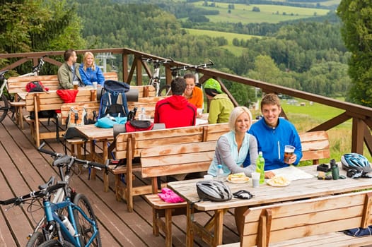 Young people relaxing looking at scenic mountain landscape  summer holiday