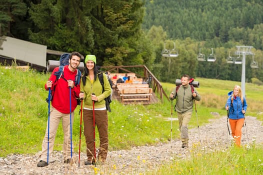 Young adventurous hiker couples following track up on the hill
