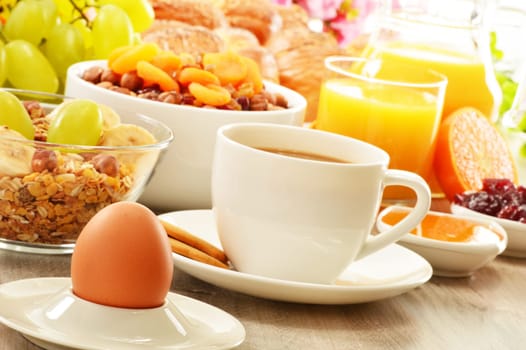 Breakfast including coffee, bread, honey, orange juice, muesli and fruits