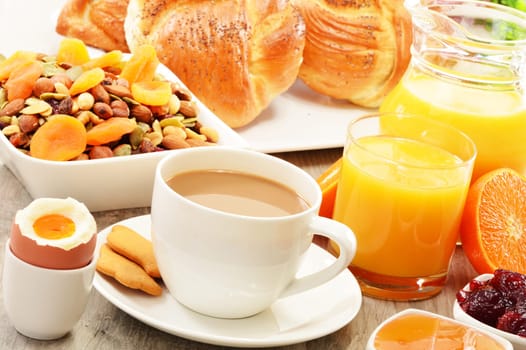 Breakfast including coffee, bread, honey, orange juice, muesli and fruits
