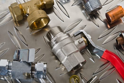 Plumbing inlet pipe valve on a metal surface