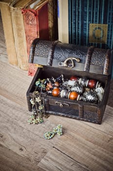 casket with jewelry and old book on a wooden surface