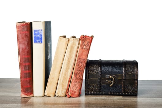 casket  and old book on a wooden surface