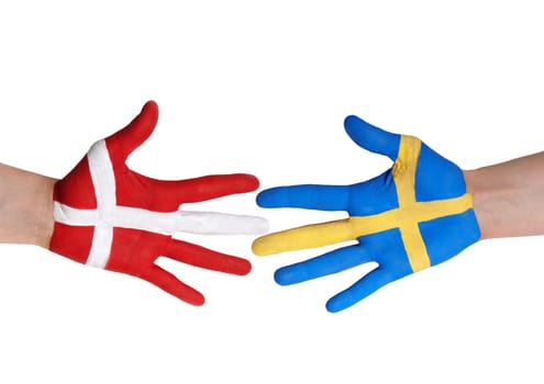 two hands painted in the colors of denmark and sweden, isolated