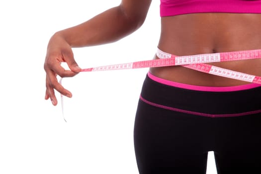 African American Fitness woman measuring her belly, isolated on white background