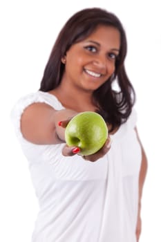 Young happy indian woman holding an apple, isolated on white background