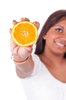 Young happy indian woman holding an orange slice, isolated on white background