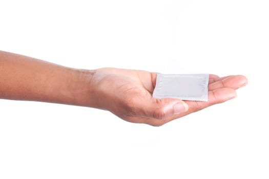 Safe sex concept. African woman Hand with condom, isolated on white background