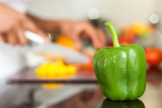 Fresh green pepper covered with water drops