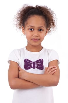Cute little African Asian girl smiling ,with folded arms