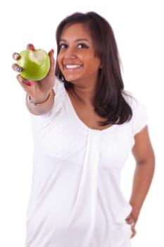 Young indian woman eating an apple, isolated on white background
