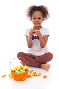 African Asian girl holding chocolate ester egg, isolated on white background