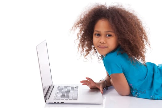 Little african asian girl using a laptop, isolated on white background