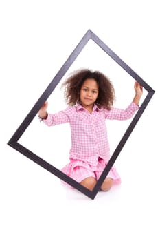 Portrait of a cute little african american girl, holding a picture frame,isolated on white background