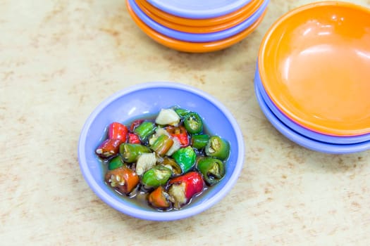 Dish of Cut Red and Green Hot Chili Peppers in Soy Sauce and Lime Juice Closeup