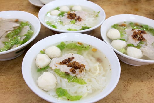 Bowls of Southeast Asian Fishball Noodle Soup with Pork Patty and Pork Lard