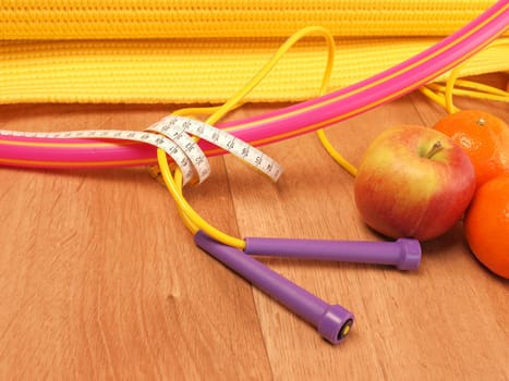 Hula hoop with measuring tape on a wooden floor