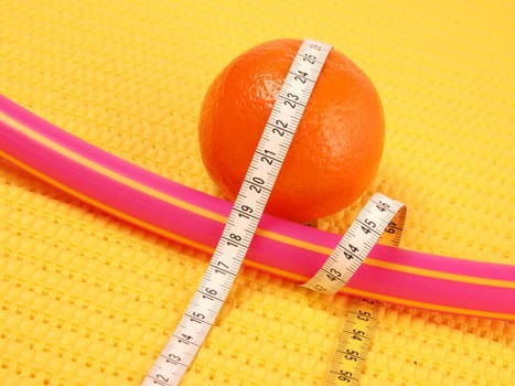Tangerine with a measuring tape