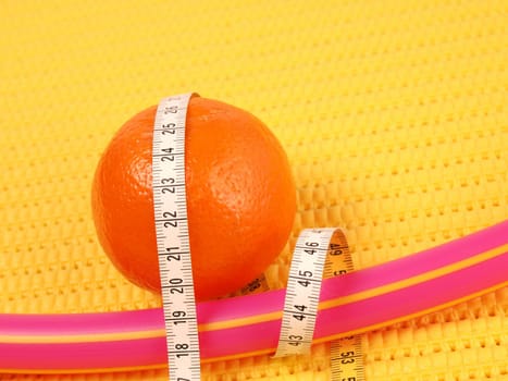 Tangerine with a measuring tape