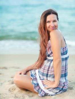 Beautiful pregnant woman on the beach
