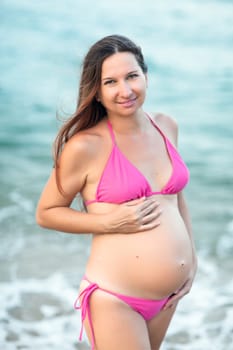 Beautiful pregnant woman on the beach