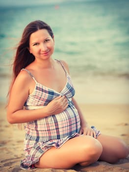 Beautiful pregnant woman on the beach