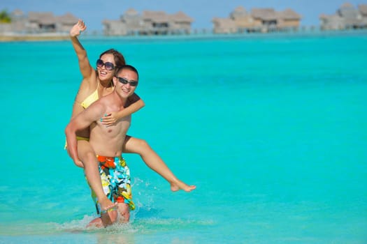 happy young asian couple have fun and romantic time at  summer on beautiful white sand beach