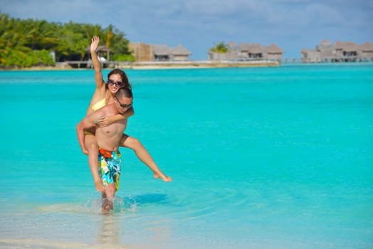 happy young asian couple have fun and romantic time at  summer on beautiful white sand beach