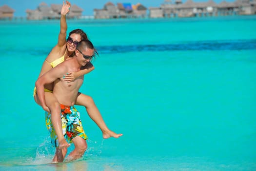 happy young asian couple have fun and romantic time at  summer on beautiful white sand beach