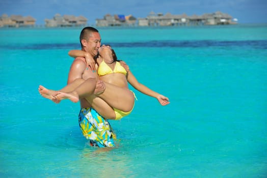 happy young asian couple have fun and romantic time at  summer on beautiful white sand beach