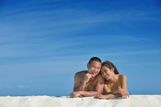 happy young asian couple have fun and romantic time at  summer on beautiful white sand beach