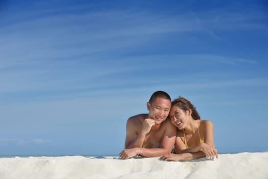 happy young asian couple have fun and romantic time at  summer on beautiful white sand beach