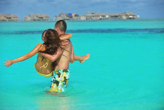 happy young asian couple have fun and romantic time at  summer on beautiful white sand beach