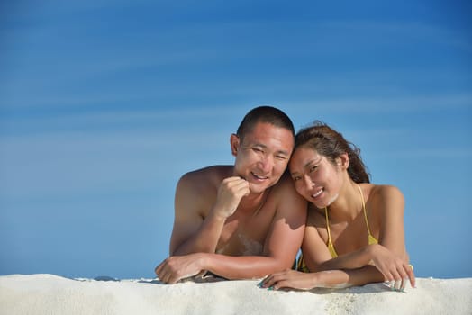 happy young asian couple have fun and romantic time at  summer on beautiful white sand beach