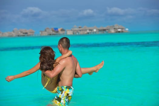 happy young asian couple have fun and romantic time at  summer on beautiful white sand beach