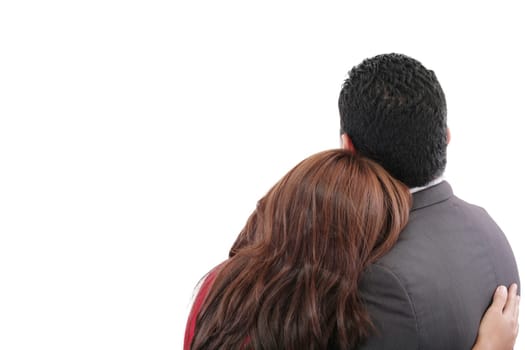 Rear view of a loving couple standing with arms around