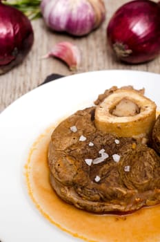Italian osso buco with sauce,red onions and garlic