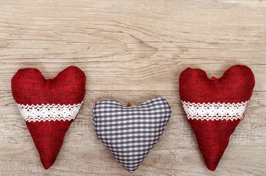 Fabric hearts on old wood with text space as advertising space